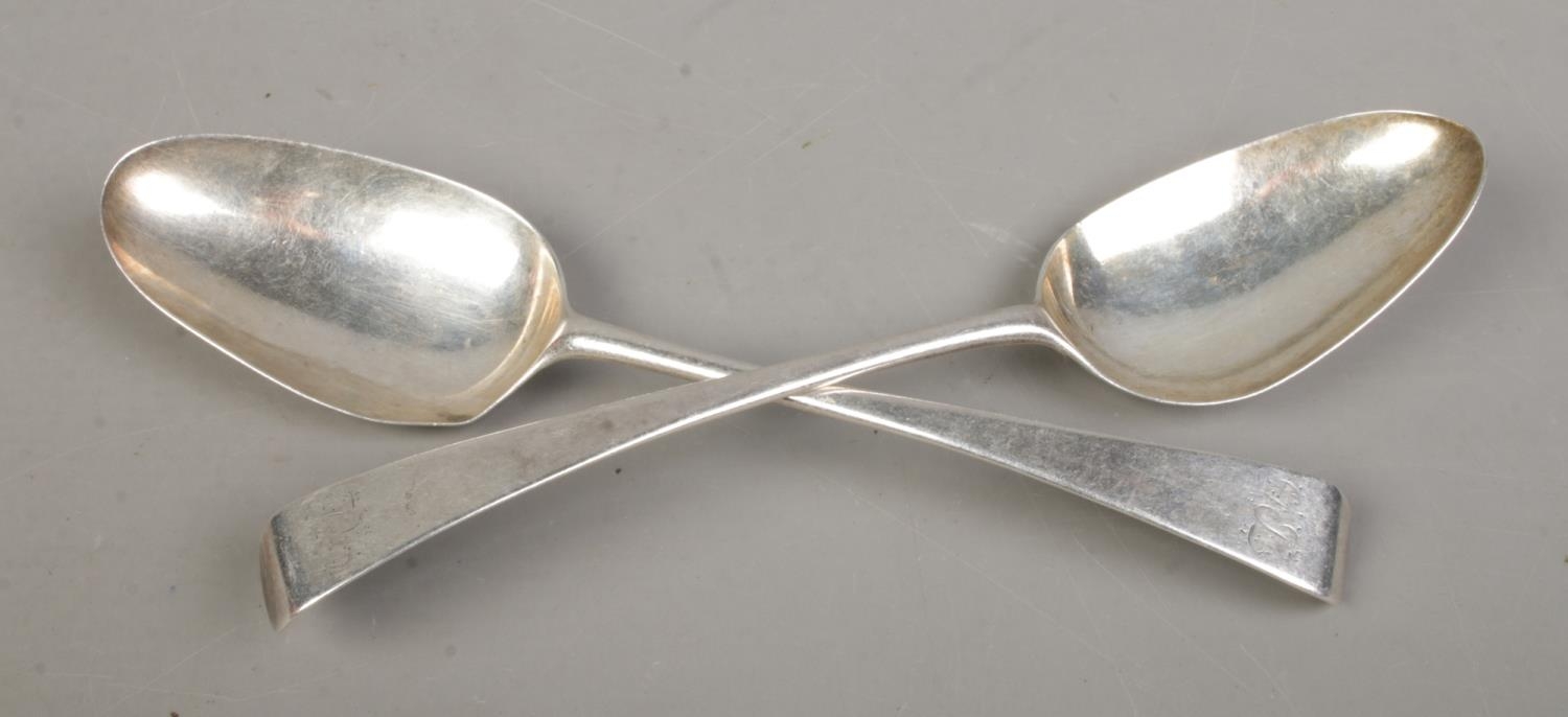 A pair of Georgian silver table spoons, with monogram to the top of the handle. Bearing partial