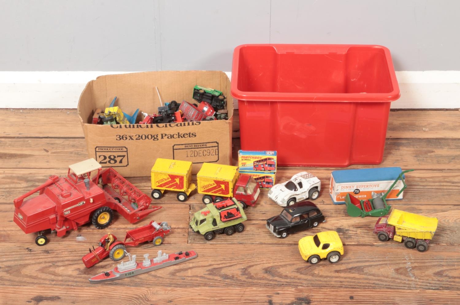 Two boxes of die cast vehicles. Includes Britains Massey Ferguson Combine Harvester, Matchbox