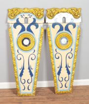 A pair of vintage fairground panels featuring gilt detail and central circular etched mirror.