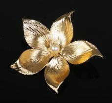 A gilt metal Henkle and Grosse (Christian Dior) flower brooch, centered with single simulated pearl.