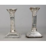 A pair of silver filled candlesticks modelled as Corinthian columns. Assayed for Birmingham, 1905 by