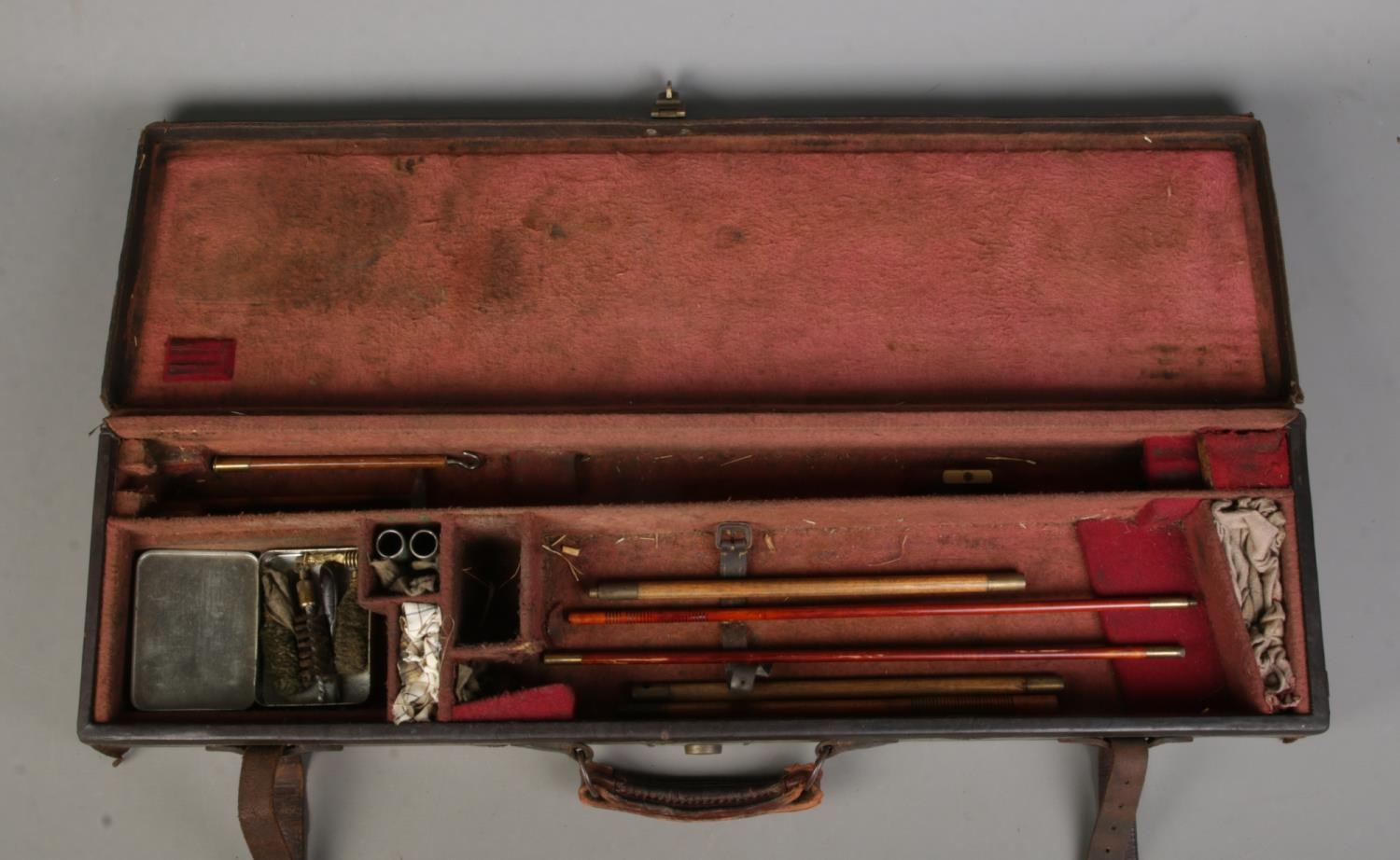 An antique leather gun case, housing an assortment of accessories, including cleaning rods. - Image 2 of 2