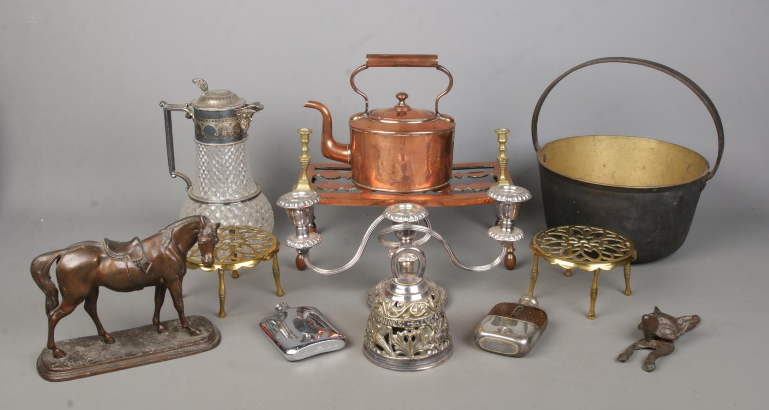 A good collection of metal wares to include three branch candelabra, trivets, copper kettle, jam