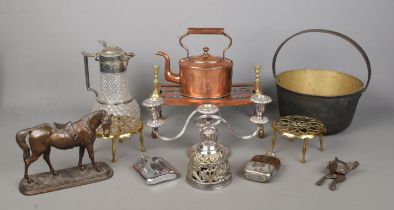 A good collection of metal wares to include three branch candelabra, trivets, copper kettle, jam