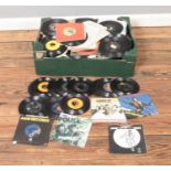 A box of assorted vinyl singles of mainly pop, rock and easy listening to include Madness, Elvis