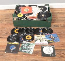 A box of assorted vinyl singles of mainly pop, rock and easy listening to include Madness, Elvis
