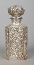 A heavily engraved silver plated decanter, bearing repousse decoration and 'BECHUR' to the base of