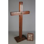 A large free standing wooden studded crucifix with a religious plaque. Crucifix has Bingham