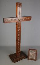 A large free standing wooden studded crucifix with a religious plaque. Crucifix has Bingham