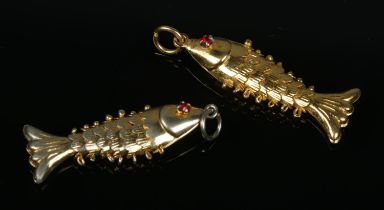 Two yellow metal articulated fish pendants, both set with red coloured eyes. Length 3cm. Total