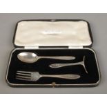 A cased three piece christening set, comprising of spoon, fork and pusher with monogram GMR. The