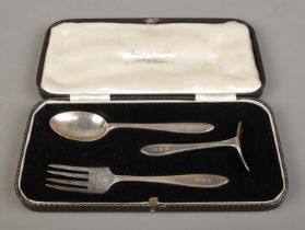 A cased three piece christening set, comprising of spoon, fork and pusher with monogram GMR. The