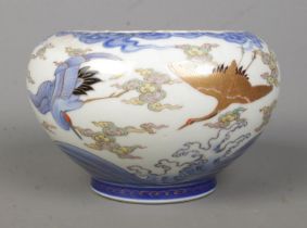 A Twentieth Century oriental bowl, with blue and white underglaze and gilt highlights, depicting