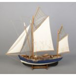 A display model of a Thonier: French Tuna fishing boat featuring cloth sails, rigging and stand with