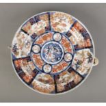 A Japanese Meiji period Imari plate warmer bearing central dragon motif and six character mark to