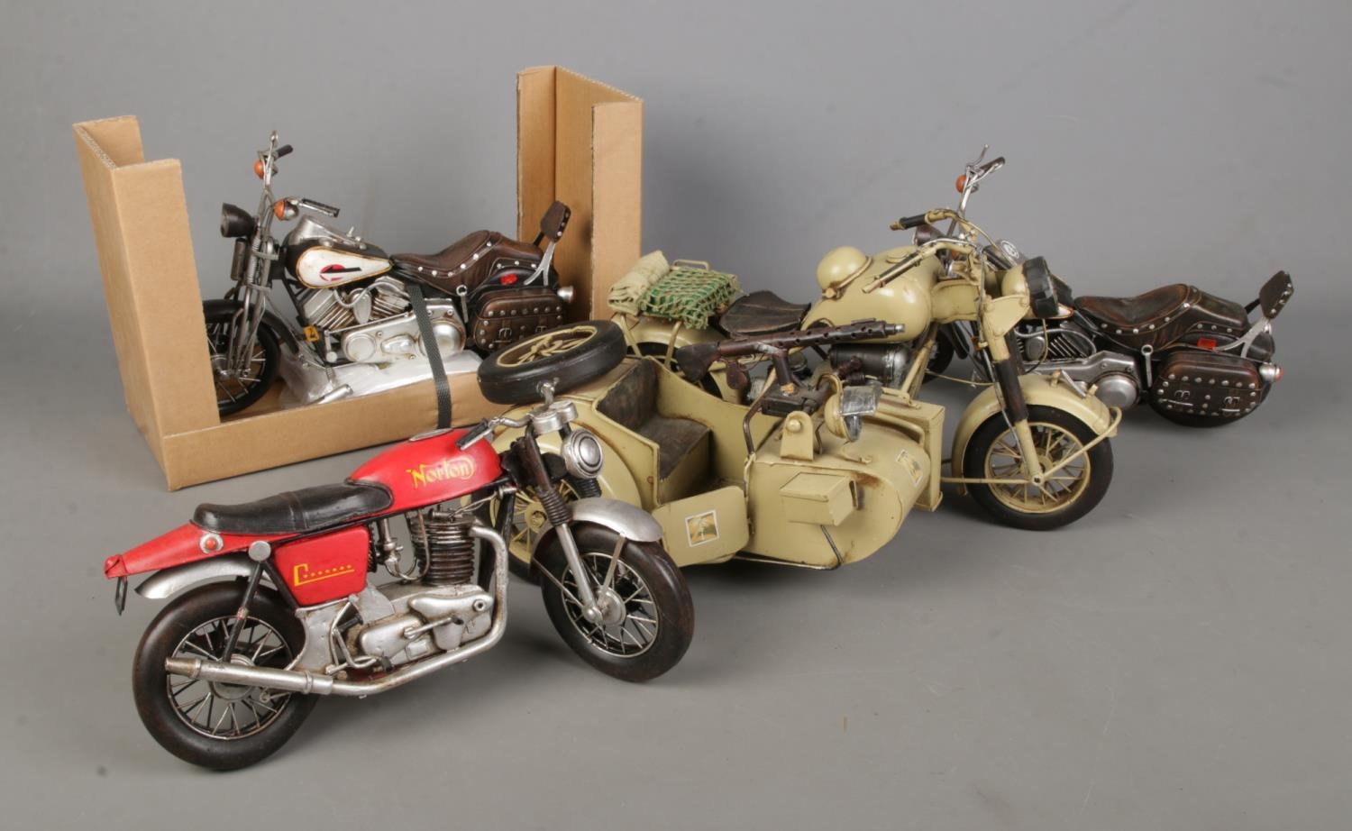 A collection of metal/tinplate motorbike models including Lesser & Pavey Norton and military
