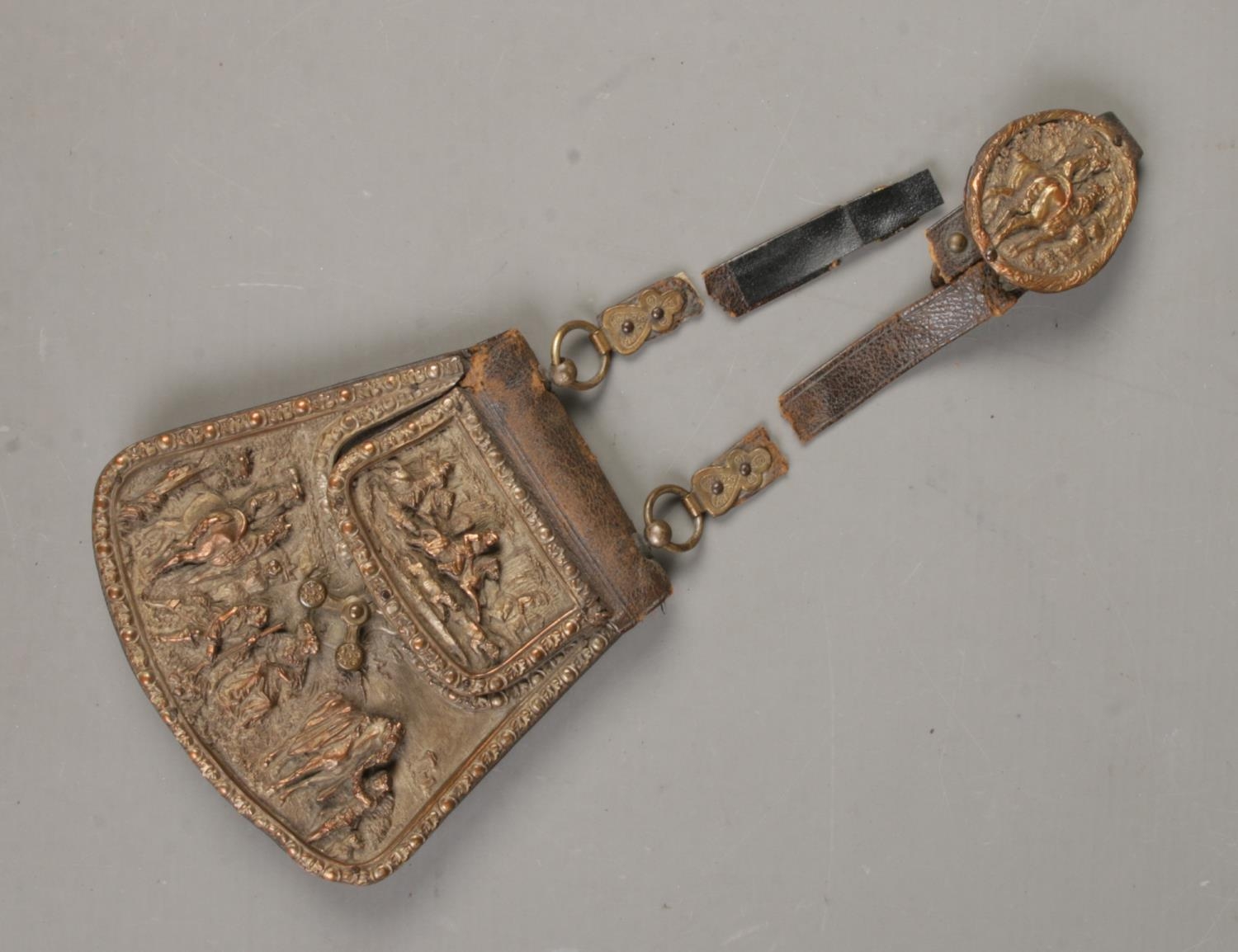 An early 20th century belt purse. Having copper front decorated with hunting scenes. Damage to