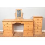 A pine dressing table/twin pedestal desk featuring four drawers to both sides, together with a table