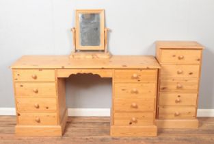 A pine dressing table/twin pedestal desk featuring four drawers to both sides, together with a table