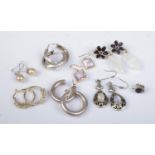 Eight pairs of silver and silver gilt earrings. Includes drop and hoop examples.