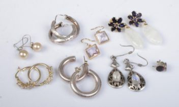 Eight pairs of silver and silver gilt earrings. Includes drop and hoop examples.