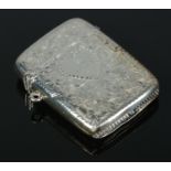An Edwardian silver vesta case, bearing floral detailing and central heart crest. Assayed for