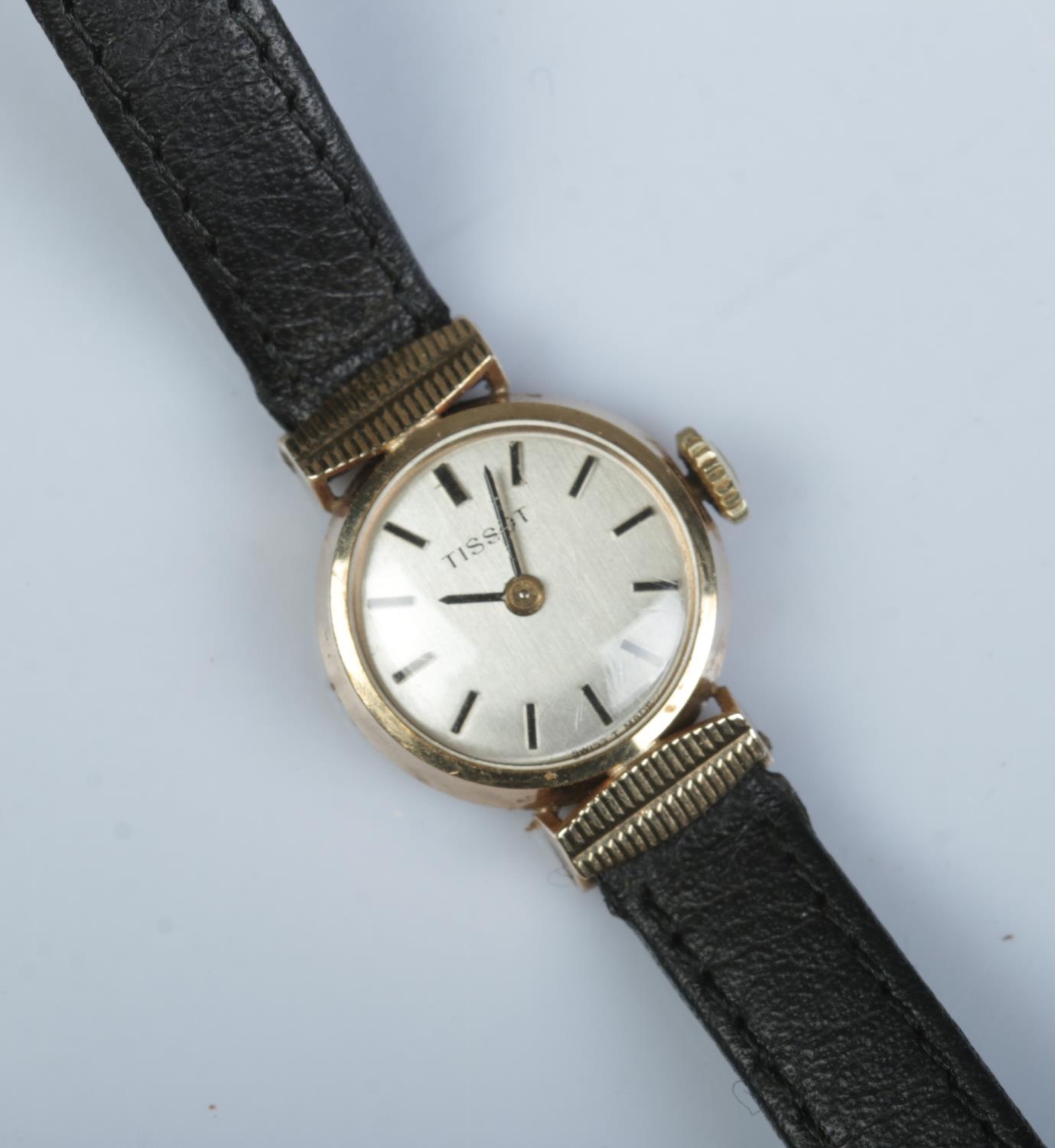 A ladies 9ct gold Tissot manual wristwatch. With box and papers.