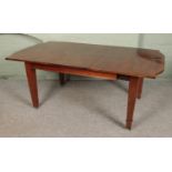 A mahogany inlaid dining table with square tapering legs sat on brass castors. Comes with one