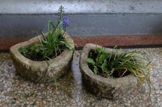 A pair of small stone demi lune troughs.