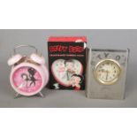 Three novelty Betty Boop clocks to include boxes heart shaped twinbell and quartz telesonic example.
