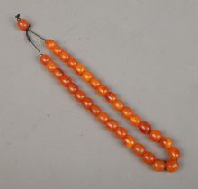 A string of butterscotch amber/copal beads. Approx. length 43cm.