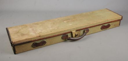 An antique green canvas and leather gun case. Bears label for John Rigby & Co.