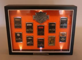 A Harley Davidson cased set of Zippo "100 Years Of American Thunder" lighters, containing 8/10