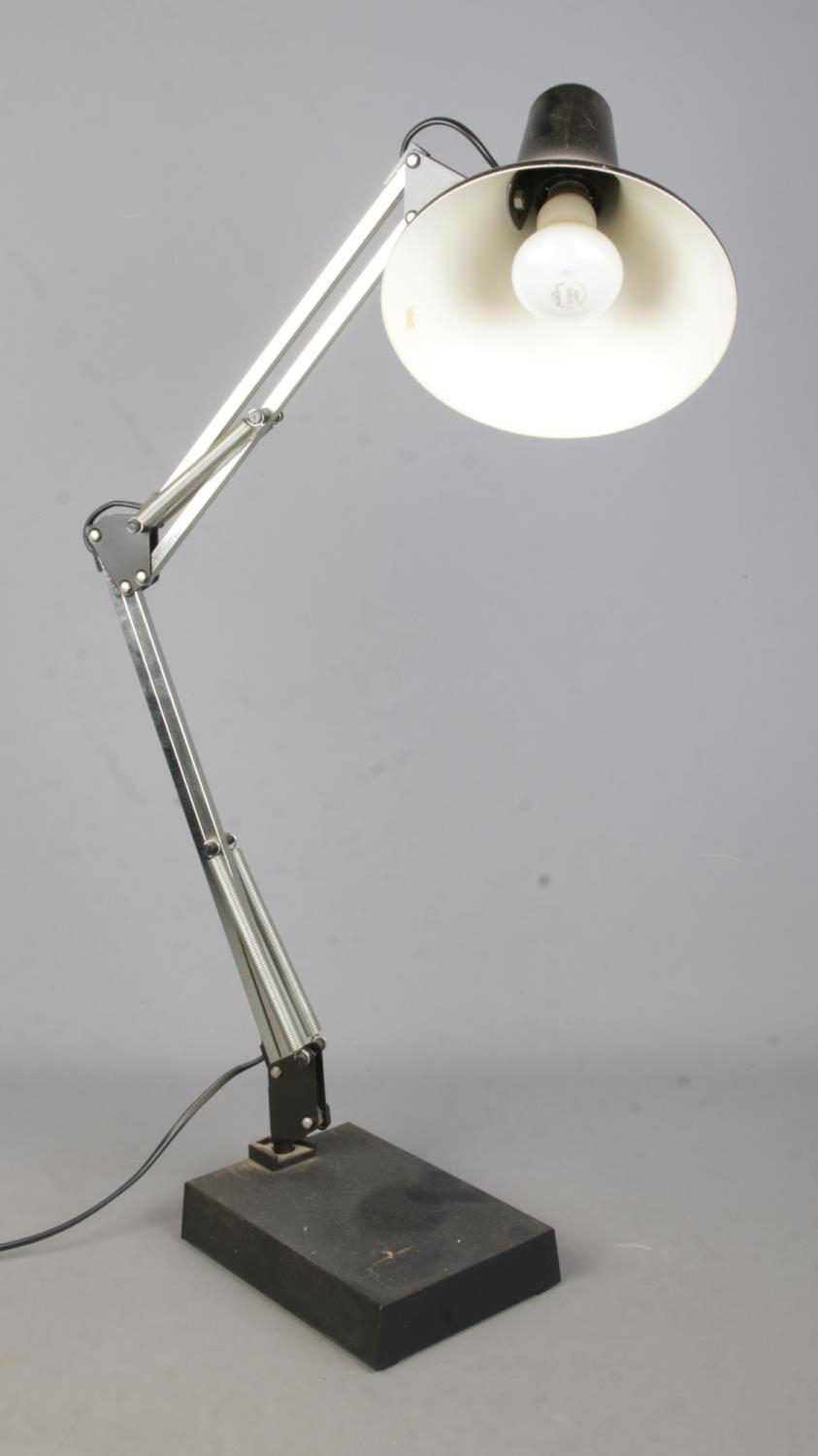 A black angle poise table lamp.