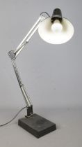 A black angle poise table lamp.