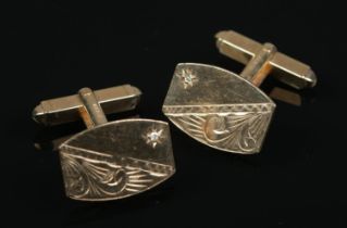 A pair of 9ct gold cufflinks. With engraved decoration and each set with a diamond chip. 6g.