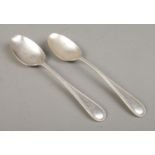 A pair of early Twentieth Century silver basting spoons, bearing G to the top of the handle. Assayed