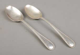 A pair of early Twentieth Century silver basting spoons, bearing G to the top of the handle. Assayed