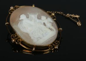 A 9ct Gold cameo brooch, depicting mother and cherub. 5cm long, total weight 8.6g.