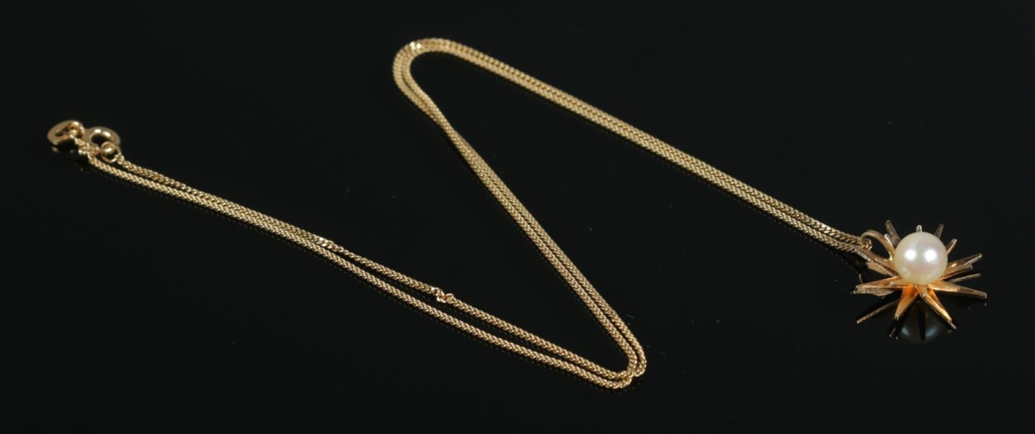 An 18ct Gold starburst shape pendant, set with central pearl, suspended on an 18ct Gold chain. Total - Image 2 of 2