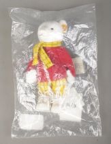 A Steiff Rupert Bear; 653551, in white, still in plastic packing bag. With yellow tag and button