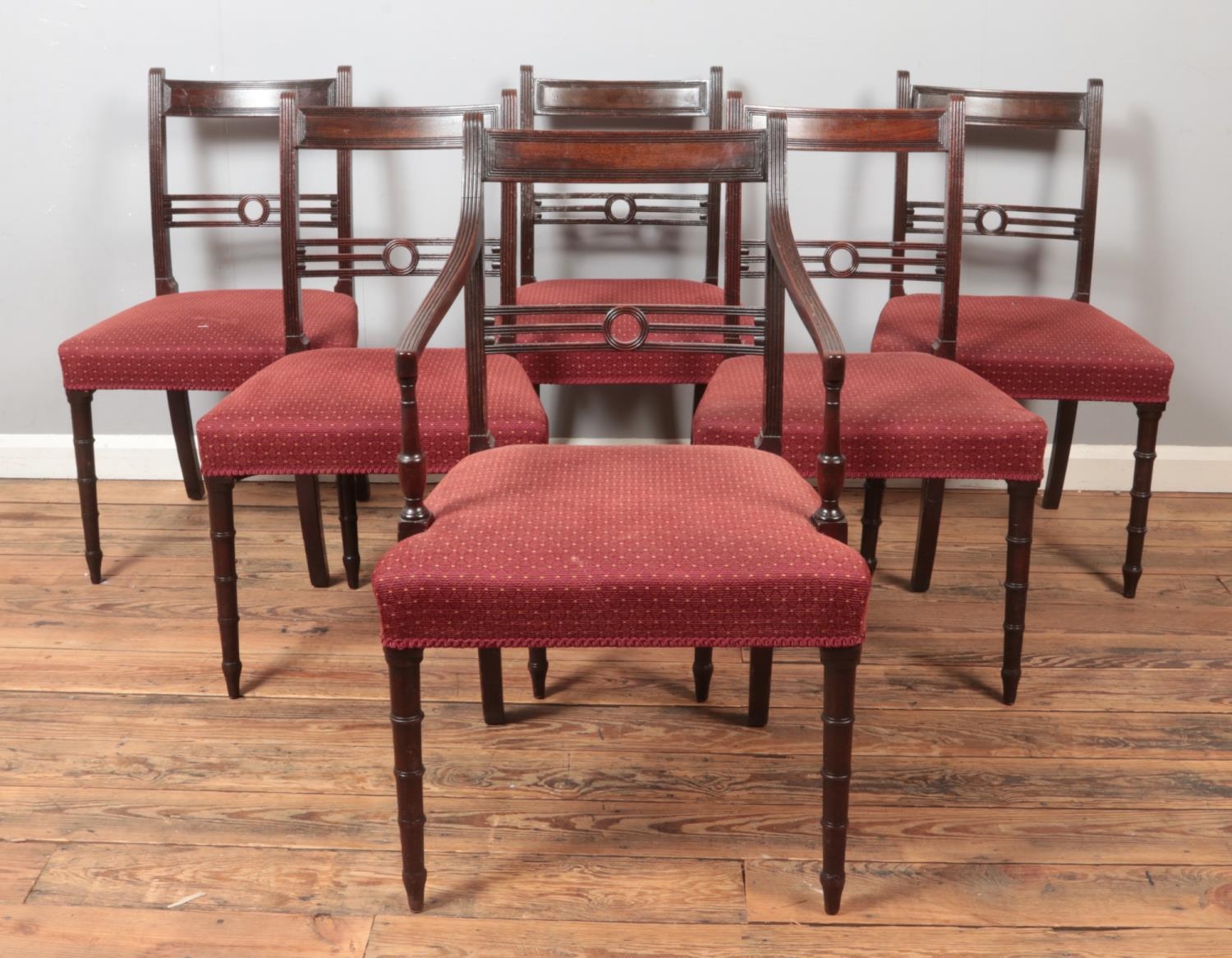 A set of six dark oak dining chairs, with unusual stranded splat and central hole, turned front legs