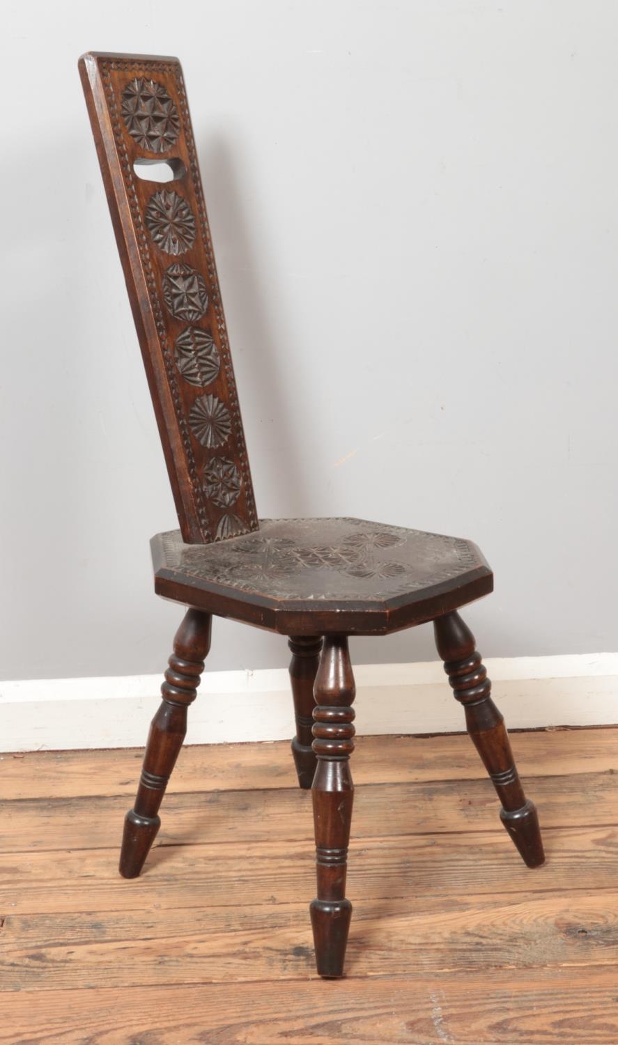 A carved hardwood spinning chair, with octagonal shaped seat and raised on turned supports.