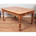 A large pine Farmhouse style table with drawers to both ends.