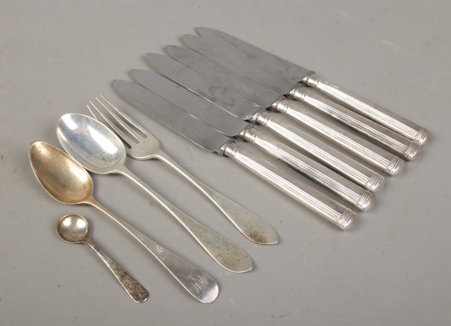 A collection of silver and silver handled flatware, to include a set of six knives assayed for