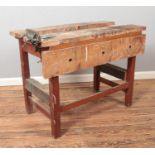 A vintage wooden work bench with Rabone Chesterman vice fitted.