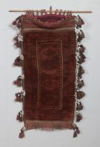 An antique Eastern saddle bag rug, with frilled and tasseled edge. Length: 112cm, Width: 55cm