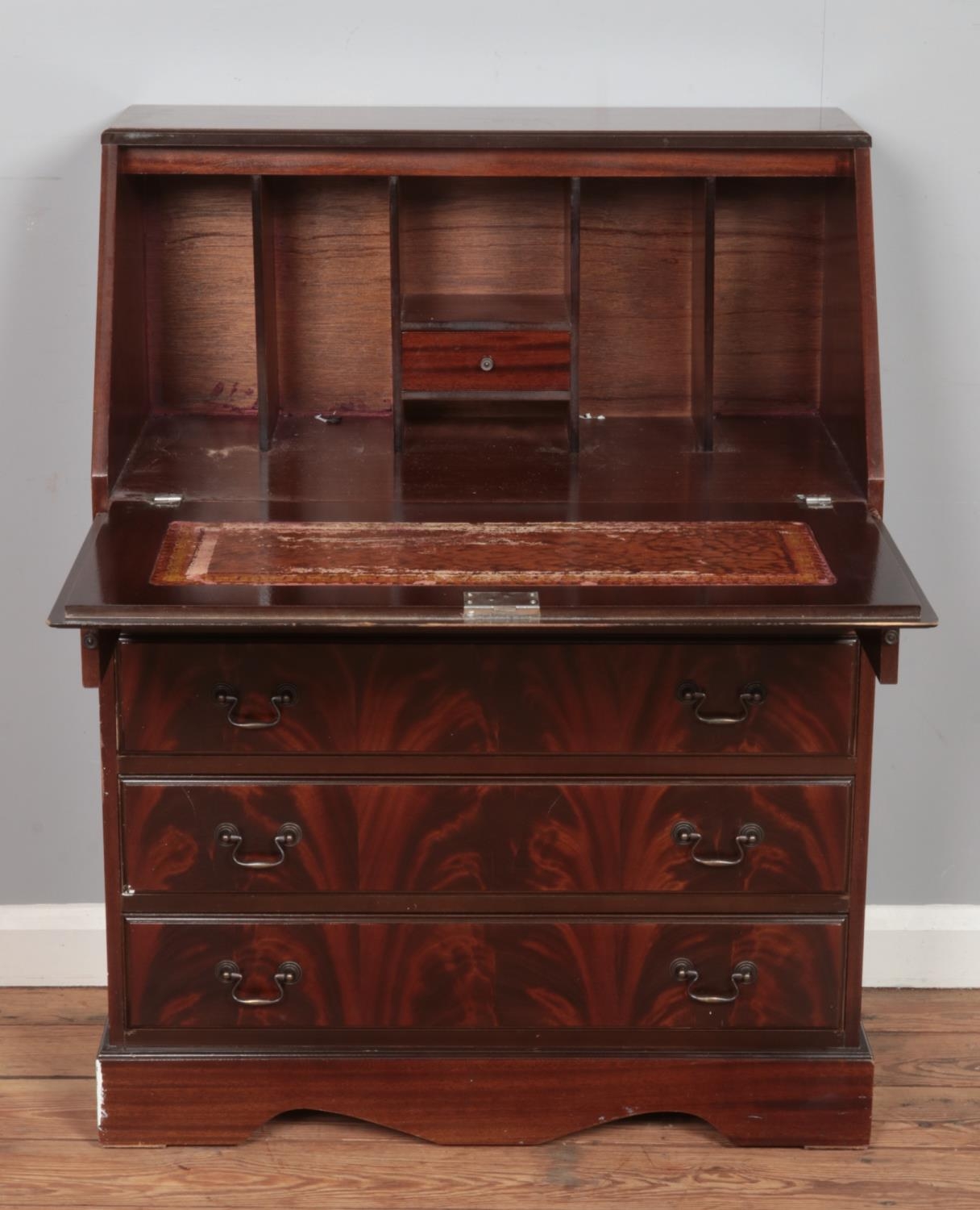 A mahogany four drawer bureau, with drop down desk revealing partially fitted interior. Height: - Image 2 of 2