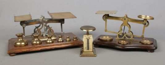 A collection of postal scales, to include balance with weights and spring loaded examples.