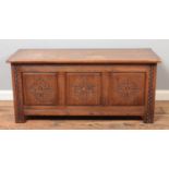 An Old Charm style paneled blanket box/coffer, with carved detailing. Height: 51cm, Width: 112cm,